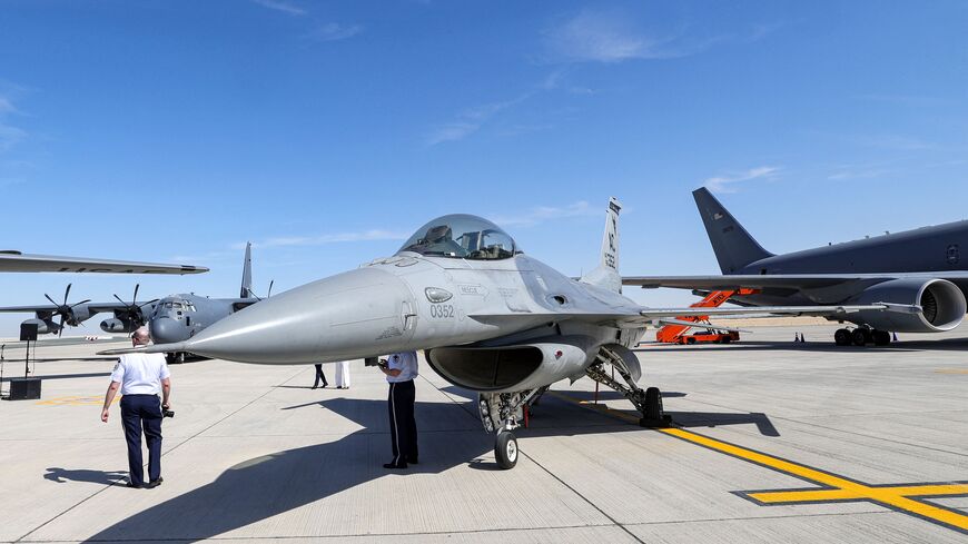 A man walks past a US Air Force (USAF) General Dynamics F-16 Fighting Falcon multirole fighter aircraft during the 2023 Dubai Airshow at Dubai World Central - Al-Maktoum International Airport in Dubai on November 13, 2023. (Photo by Giuseppe CACACE / AFP) (Photo by GIUSEPPE CACACE/AFP via Getty Images)